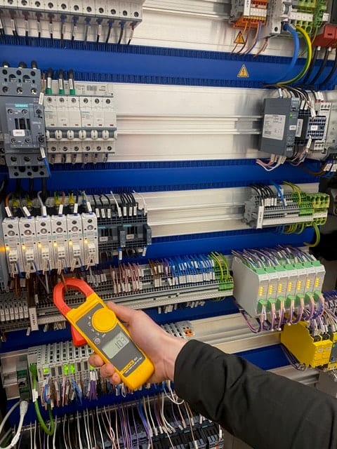 Industrial engineer diagnosing machinery in a factory