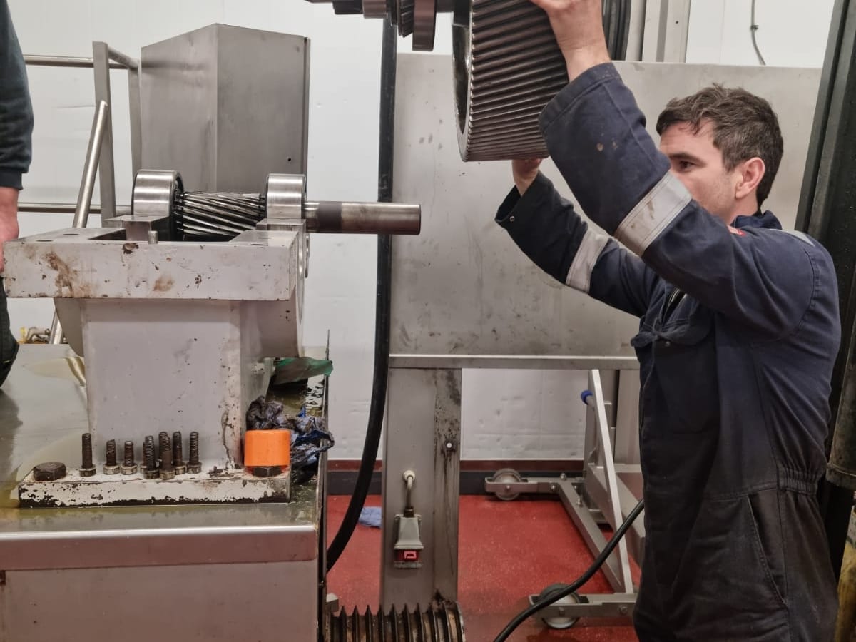 Engineers inspecting machinery in a heavy industrial factory